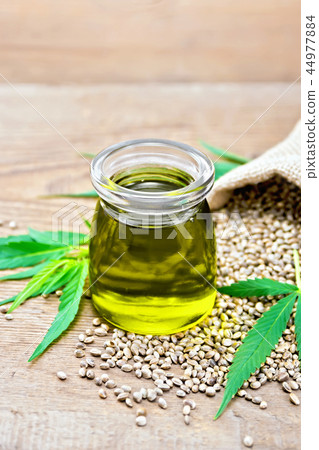 Oil hemp in jar with sheet on board 44977884
