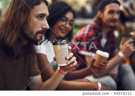 Thoughtful young man drinking coffee and looking into the distance Thoughtful young man drinking coffee and looking into the distance 44978312