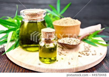 Oil hemp in two jars with flour on board Oil hemp in two jars with flour on board 44978448