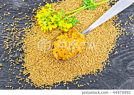 Sauce mustard Dijon in spoon with flower on board 44978992
