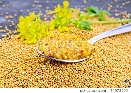 Sauce mustard Dijon in spoon with flower on board Sauce mustard Dijon in spoon with flower on board 44978993