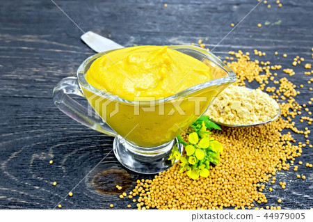 Sauce mustard in sauceboat with powder on board Sauce mustard in sauceboat with powder on board 44979005