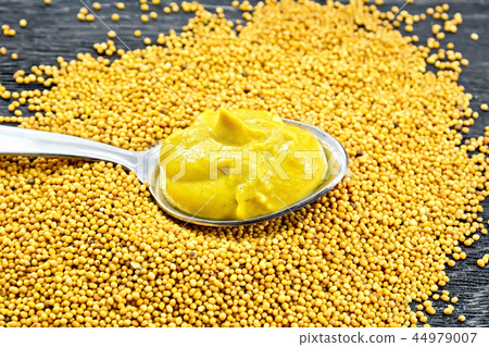 Sauce mustard in spoon on board 44979007