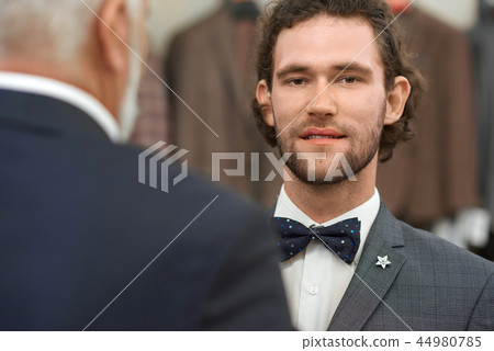 Hadsome young guy in jacket and bow tie looking at camera. Hadsome young guy in jacket and bow tie looking at camera. 44980785
