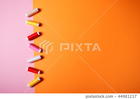 Colorful sewing threads on bright background. Colorful sewing threads on bright background. 44981217