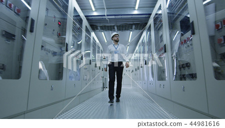 Electrical worker walking down the hall 44981616