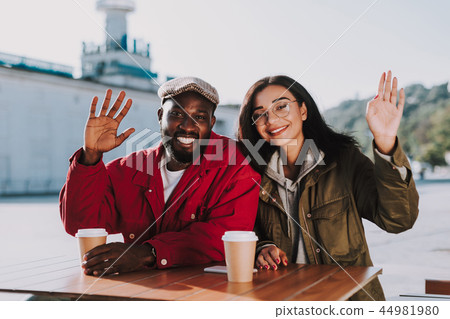 Emotional couple waving hands while sitting at the table Emotional couple waving hands while sitting at the table 44981980