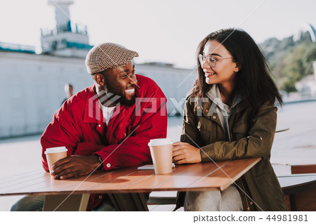 Expressive man laughing while looking at his girlfriend Expressive man laughing while looking at his girlfriend 44981981