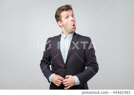 Portrait of young amazed man isolated on gray background Portrait of young amazed man isolated on gray background 44982981