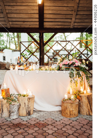 Rustic wedding decor on a timber background. Main table setting for bride and groom newlyweds Rustic wedding decor on a timber background. Main table setting for bride and groom newlyweds 44986216