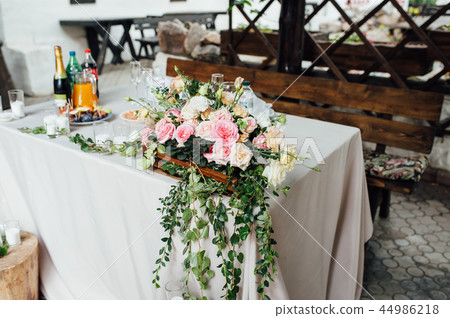 Rustic wedding decor on a timber background. Main table setting for bride and groom newlyweds Rustic wedding decor on a timber background. Main table setting for bride and groom newlyweds 44986218