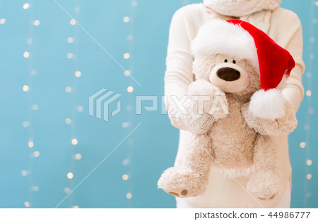 Woman holding a teddy bear Woman holding a teddy bear 44986777