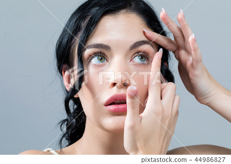Young woman with contact lenses Young woman with contact lenses 44986827