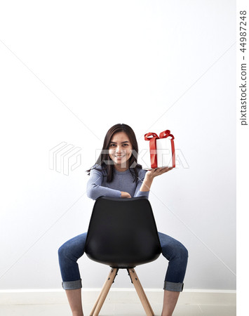 young girl with christmas gift 44987248