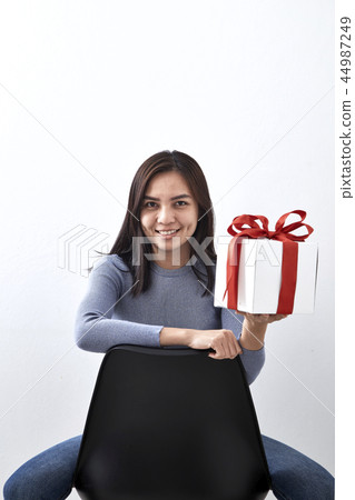 young girl with christmas gift young girl with christmas gift 44987249