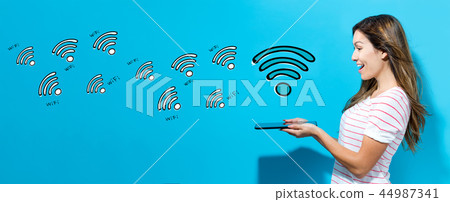 WiFi theme with woman using a tablet 44987341
