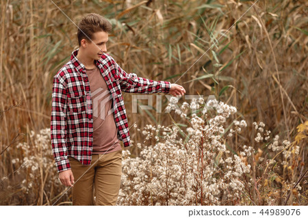 Handsome young guy in nature on an autumn day Handsome young guy in nature on an autumn day 44989076