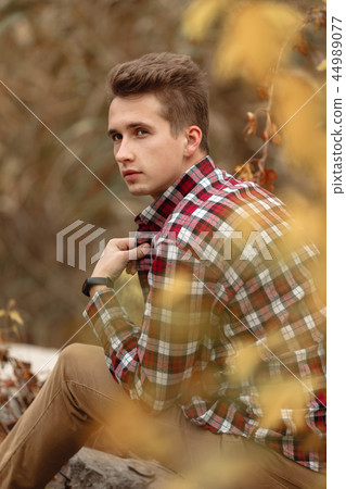 Handsome young guy in nature on an autumn day Handsome young guy in nature on an autumn day 44989077