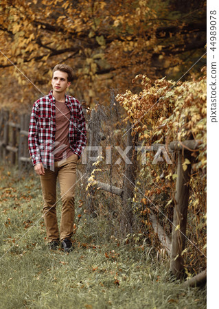 Handsome young guy in nature on an autumn day Handsome young guy in nature on an autumn day 44989078