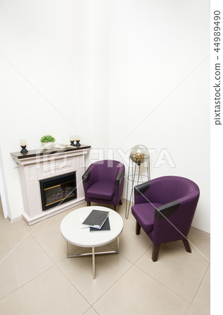 Lounge area with chairs and fireplace Lounge area with chairs and fireplace 44989490