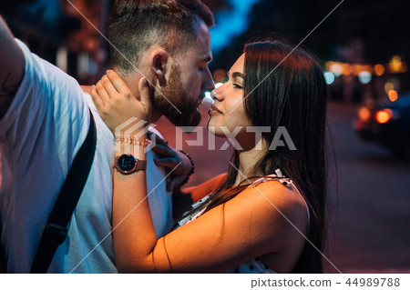 Young couple in the streets of the evening city Young couple in the streets of the evening city 44989788