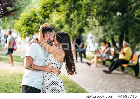 Handsome guy and young girl hugging in the park. 44989789
