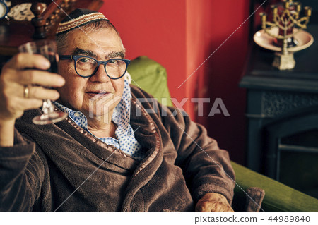 Jewish senior drinking kosher wine 44989840