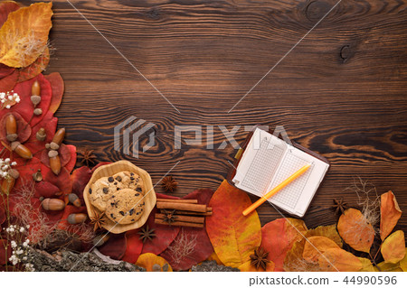 autumn leaves, cookies and paper notebook on wooden background autumn leaves, cookies and paper notebook on wooden background 44990596