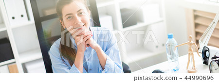 Young girl in the office sits at the computer desk. 44990696