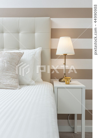 Modern bedroom with pillows and a bed for tourists. Frontally. Modern bedroom with pillows and a bed for tourists. Frontally. 44990988