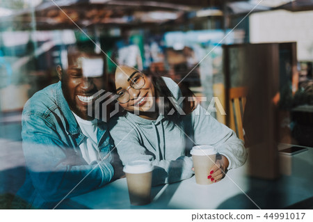 Expressive man hugging his girlfriend and smiling happily Expressive man hugging his girlfriend and smiling happily 44991017