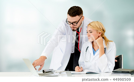 Doctors working with laptop computer in hospital. 44998509