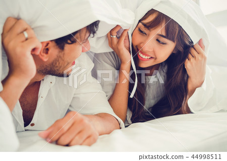 Happy young couple relaxing in the home bedroom. 44998511