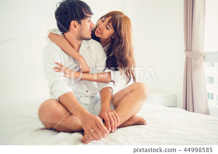 Happy young couple relaxing in the home bedroom. Happy young couple relaxing in the home bedroom. 44998585