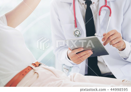 Male Doctor and Female Patient in Hospital Office Male Doctor and Female Patient in Hospital Office 44998595
