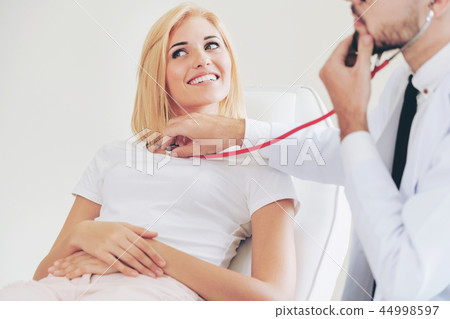 Male Doctor and Female Patient in Hospital Office Male Doctor and Female Patient in Hospital Office 44998597