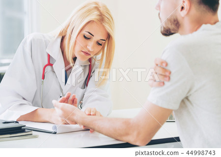 Woman Doctor and Male Patient in Hospital Office 44998743