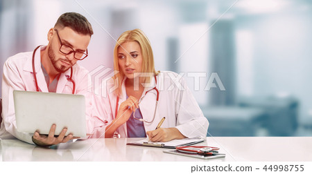 Doctors working with laptop computer in hospital. 44998755