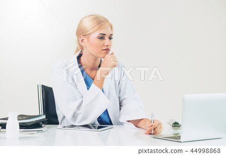 Doctor in hospital working on medical report. 44998868