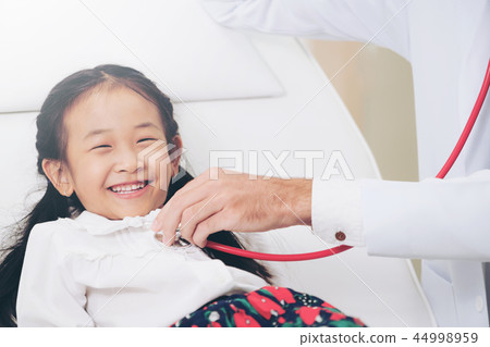 Doctor examining little happy kid in hospital. Doctor examining little happy kid in hospital. 44998959