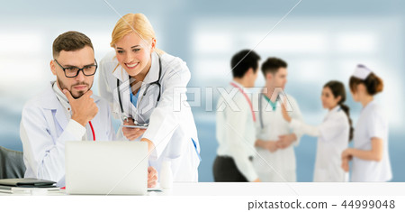 Doctor working in hospital with other doctors. Doctor working in hospital with other doctors. 44999048