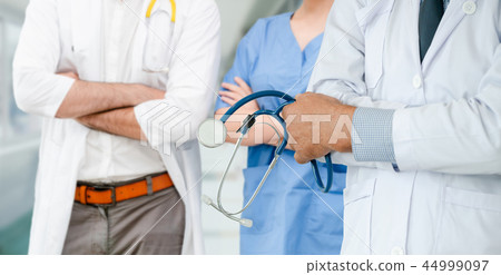 Doctor working in hospital with other doctors. 44999097