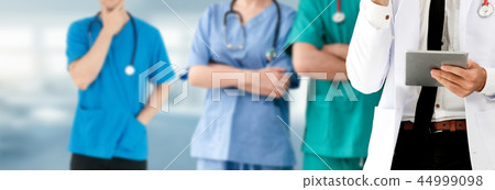 Doctor working in hospital with other doctors. Doctor working in hospital with other doctors. 44999098