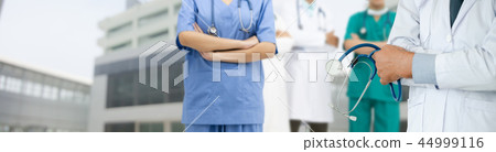 Doctor working in hospital with other doctors. 44999116