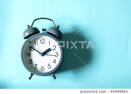 The Alarm clock on bright blue background The Alarm clock on bright blue background 44999665