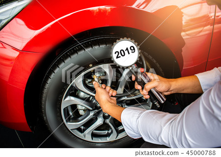 Asian man car inspection Measure quantity Inflated 45000788