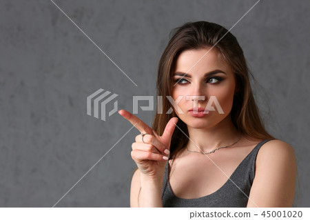 A caucasian woman on a gray background A caucasian woman on a gray background 45001020