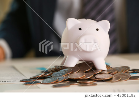 Hand businessman putting pin money into pig 45001192