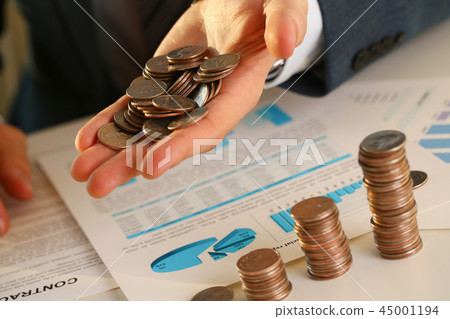 Hand businessman putting pin money into pig 45001194