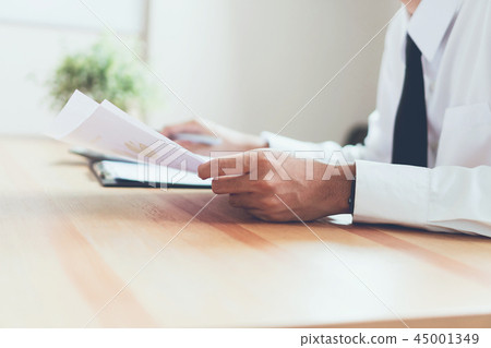 Businessman working at office with sign a document Businessman working at office with sign a document 45001349